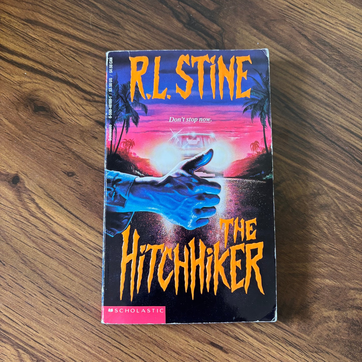 The Hitchhiker by R.L. Stine - 1993 Scholastic YA Thriller Paperback with a suspenseful cover, perfect for young adult readers who enjoy chilling mystery and thrilling plots.