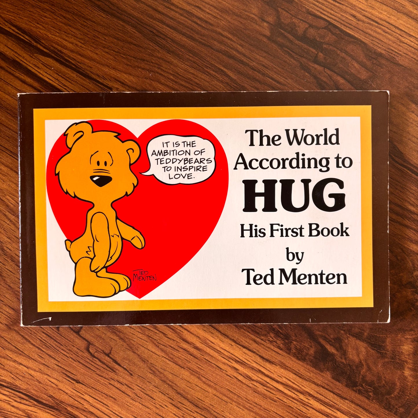 The World According to HUG by Ted Menten. This sweet softcover cartoon book is filled with cozy bear wisdom, charming illustrations, and feel-good 80s vibes