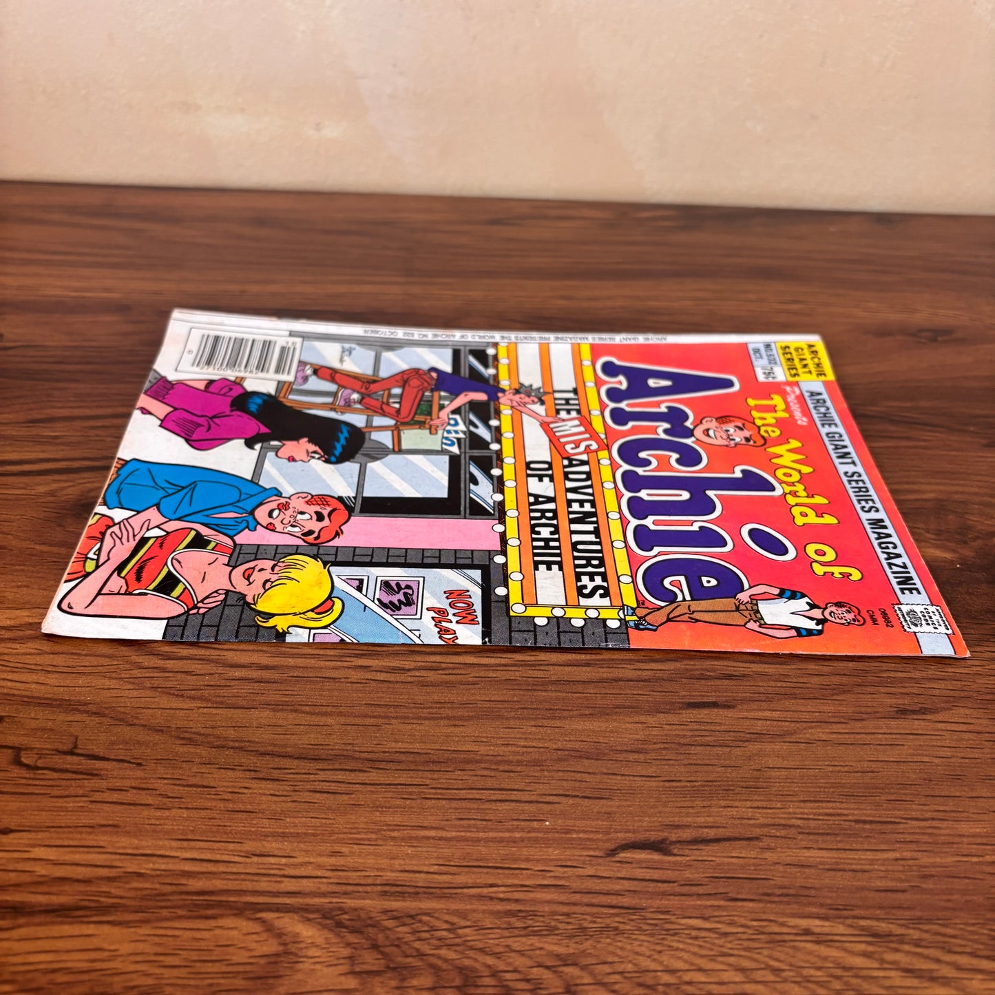 1983 World of Archie comic magazine with a movie theater cover scene, showing Archie caught between Betty and Veronica under a bold marquee sign.