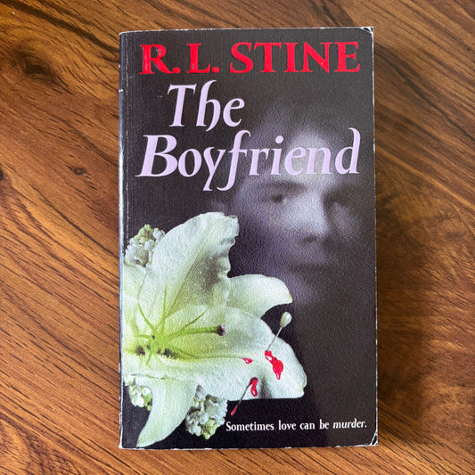 Rare 1990 paperback cover of The Boyfriend by R.L. Stine, featuring a striking face design with a mysterious and eerie expression, perfect for collectors and fans of classic YA thriller and horror novels.