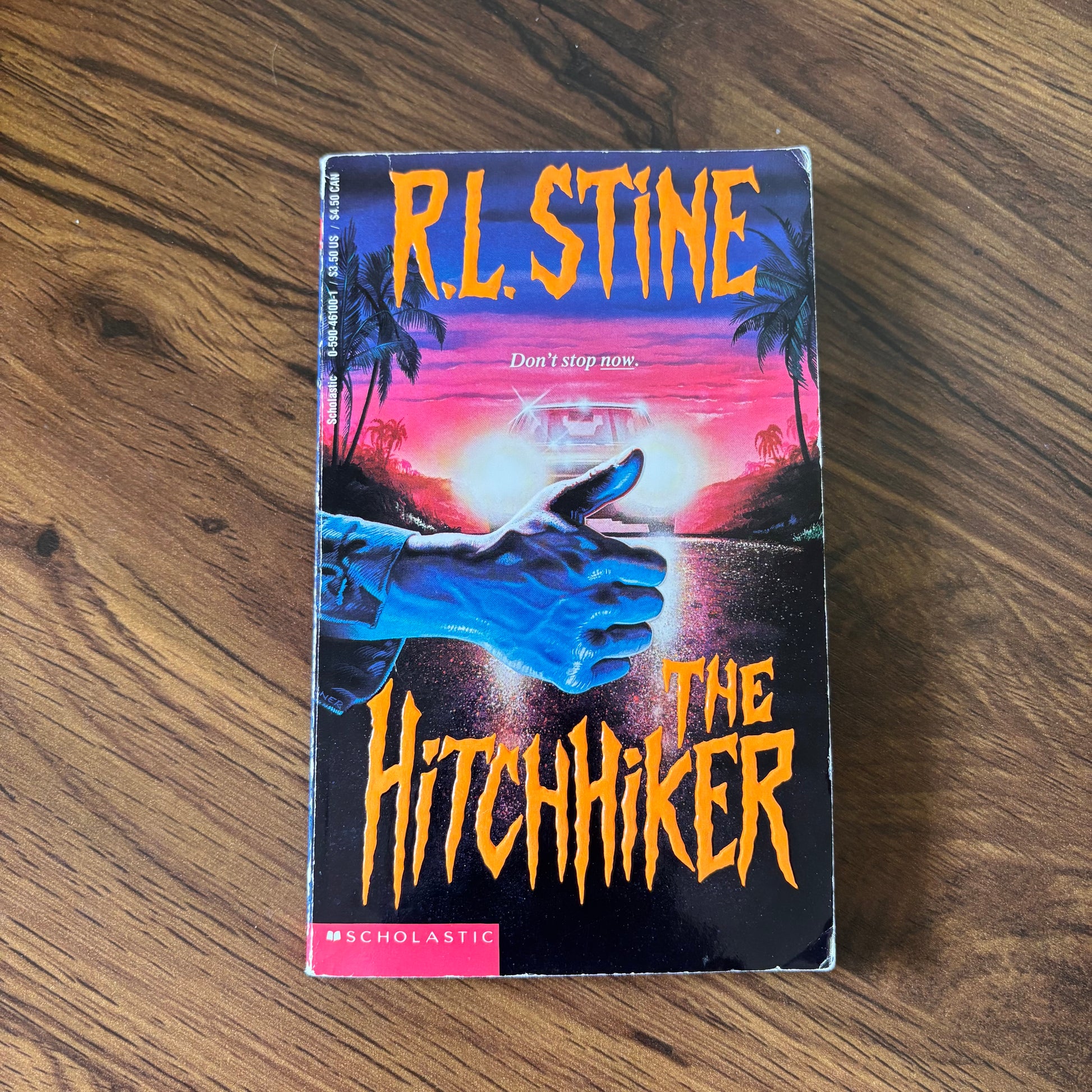 The Hitchhiker by R.L. Stine - 1993 Scholastic YA Thriller Paperback with a suspenseful cover, perfect for young adult readers who enjoy chilling mystery and thrilling plots.