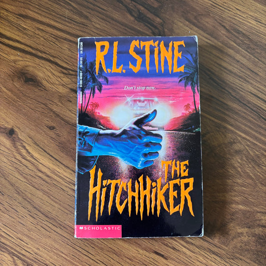 The Hitchhiker by R.L. Stine - 1993 Scholastic YA Thriller Paperback with a suspenseful cover, perfect for young adult readers who enjoy chilling mystery and thrilling plots.