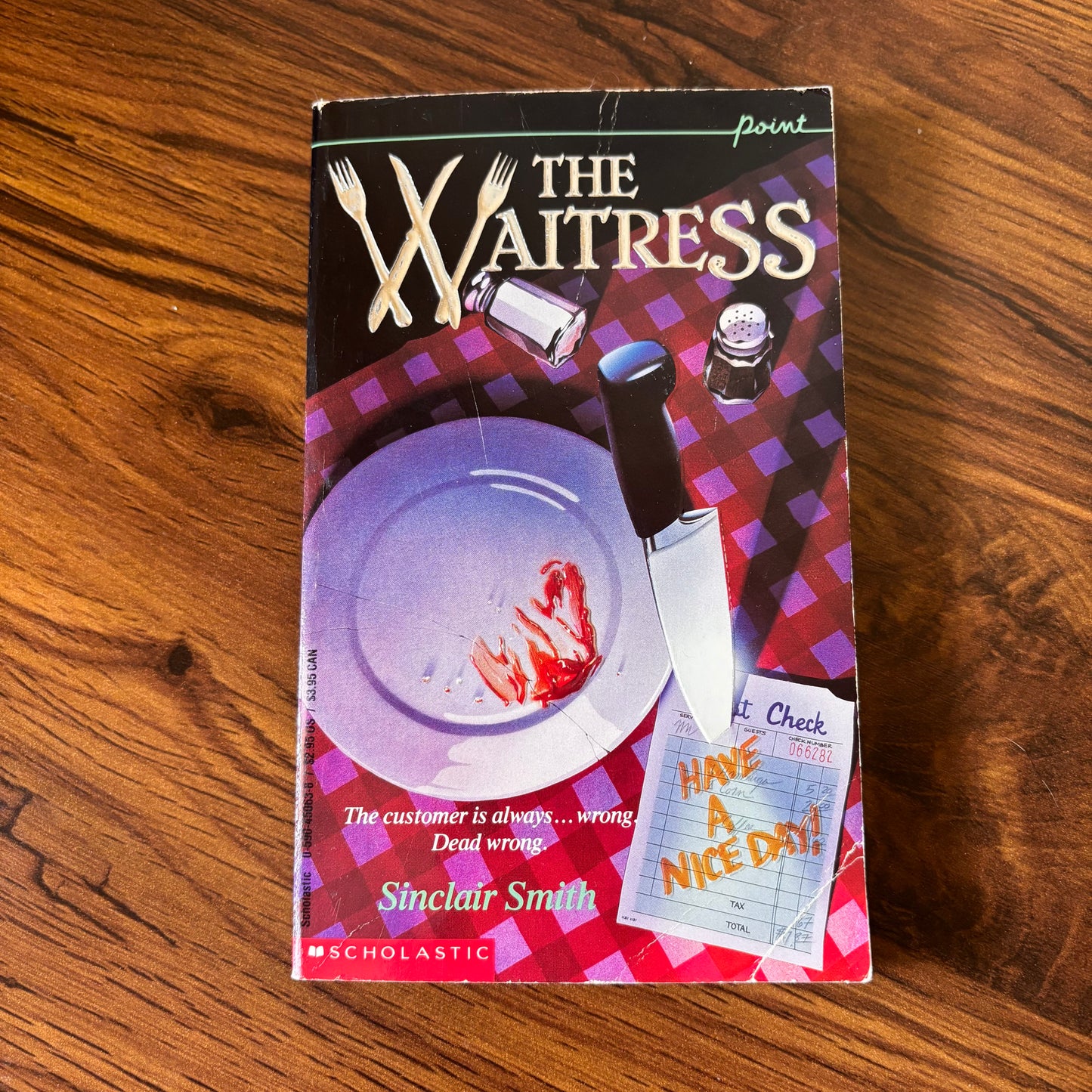 The Waitress by Sinclair Smith - 1992 Point Fiction Thriller Paperback featuring a bloody dinner plate on the cover. This suspenseful crime thriller novel with a dark, gripping storyline is perfect for fans of murder mysteries and psychological thrillers. The cover design vividly portrays a chilling scene with a bloodstained plate, setting the tone for the eerie narrative inside.