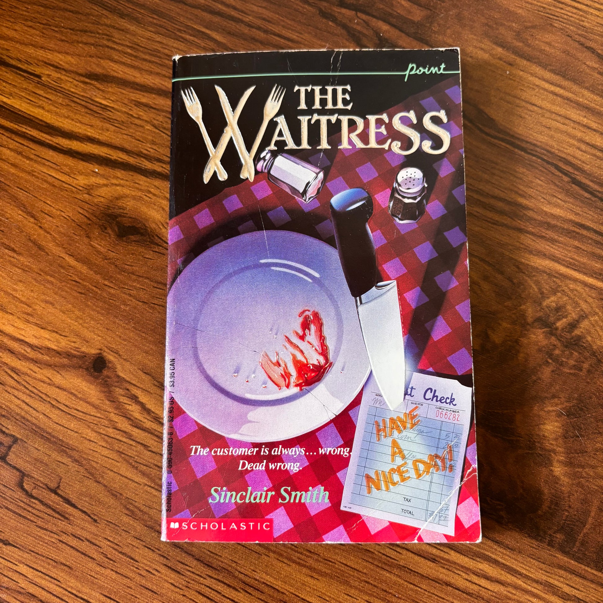 The Waitress by Sinclair Smith - 1992 Point Fiction Thriller Paperback featuring a bloody dinner plate on the cover. This suspenseful crime thriller novel with a dark, gripping storyline is perfect for fans of murder mysteries and psychological thrillers. The cover design vividly portrays a chilling scene with a bloodstained plate, setting the tone for the eerie narrative inside.