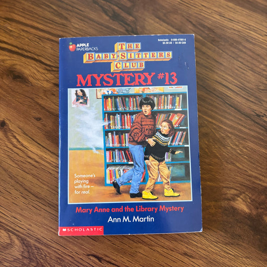Baby-Sitters Club Mystery #13: The Library Mystery by Ann M. Martin - Scholastic paperback edition, a captivating mystery where the Baby-Sitters Club investigates strange happenings at the local library!