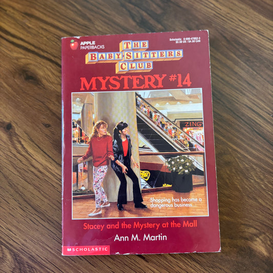 The Baby-Sitters Club Mystery #14: Stacey and the Mystery at the Mall by Ann M. Martin - 1994 Scholastic paperback edition, a suspenseful mystery where Stacey and the Baby-Sitters Club uncover strange events at the local mall.