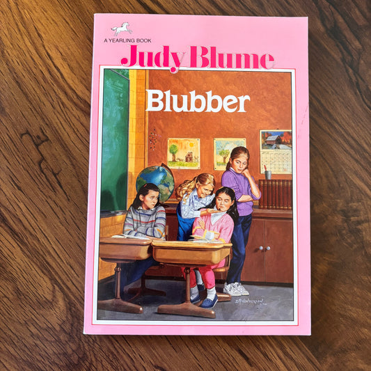 1986 Yearling paperback edition of Blubber by Judy Blume with the pink cover design. Timeless coming-of-age story from the 80s with bold themes, school drama, and classic vintage styling.