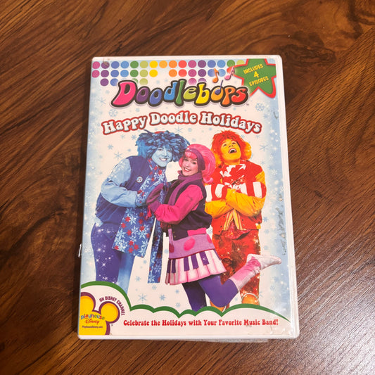 oodlebops Happy Doodle Holidays DVD (2005). Features DeeDee, Rooney, and Moe in 4 festive episodes packed with songs, laughs, and bonus features. A nostalgic 2000s kids TV holiday special.
