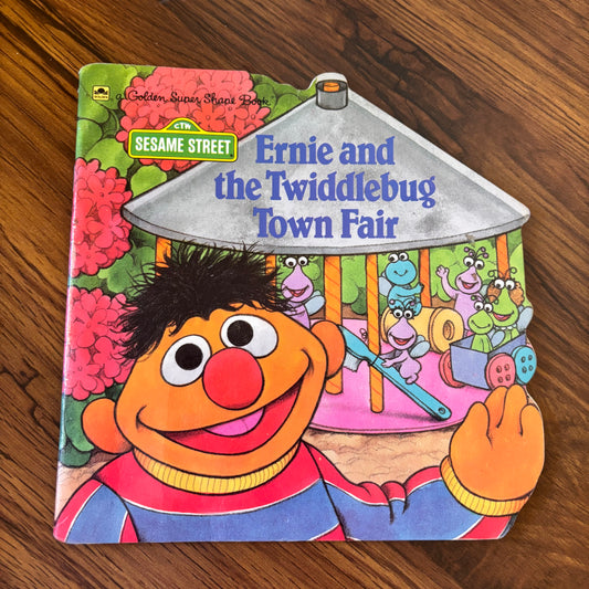 1990 Sesame Street Golden Super Shape Book Ernie and the Twiddlebug Town Fair. Uniquely shaped vintage children’s book featuring Ernie and the Twiddlebugs in a colorful 90s adventure.