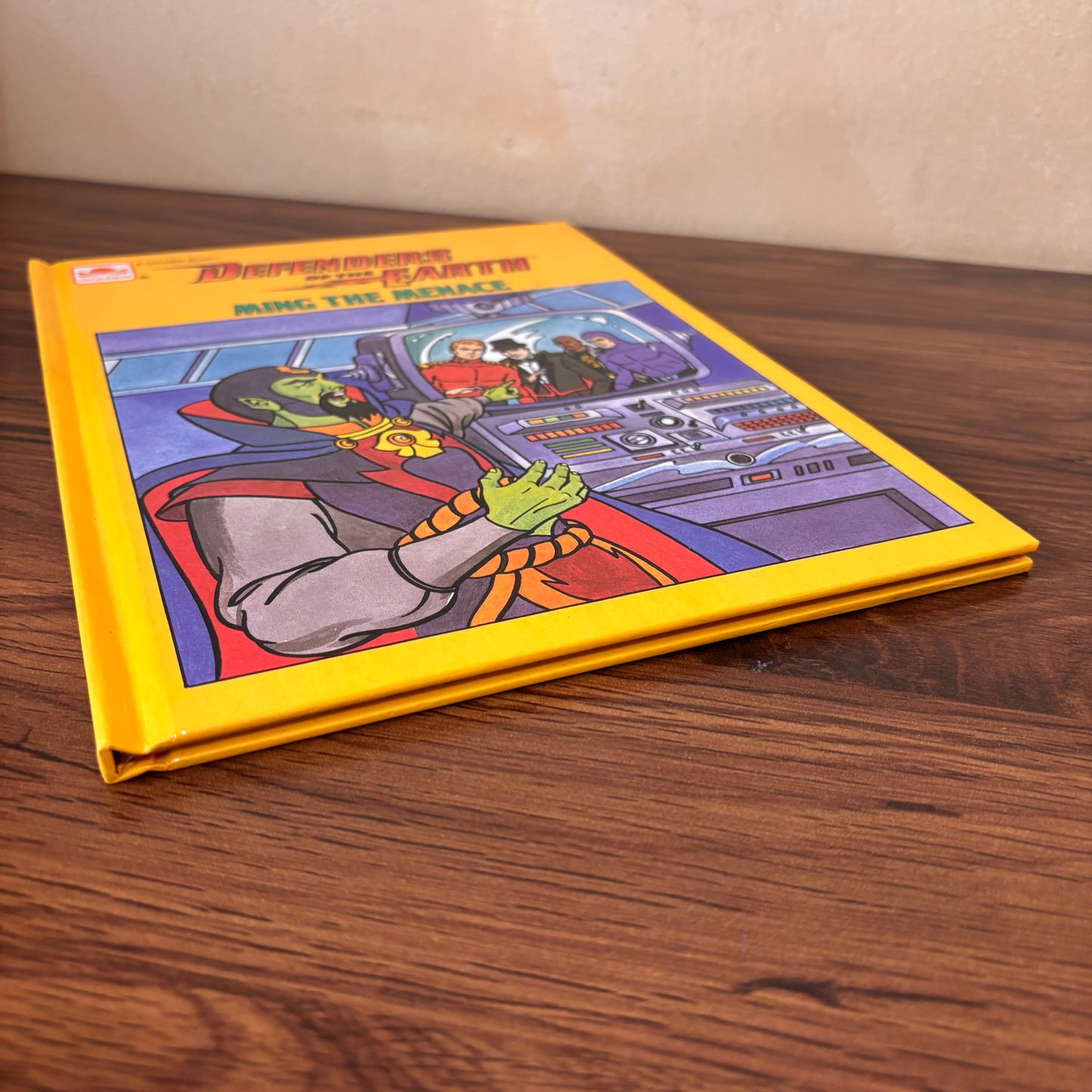 Golden Book Defenders of the Earth Ming the Menace hardcover featuring bold yellow cover art, sci-fi control panel scene, vintage cartoon characters, and 1986 children’s book nostalgia.