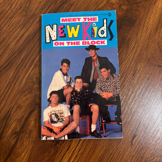 Cover of Meet the New Kids on the Block, a 1990 Signet non-fiction paperback featuring the popular boy band during their peak early 1990s fame.