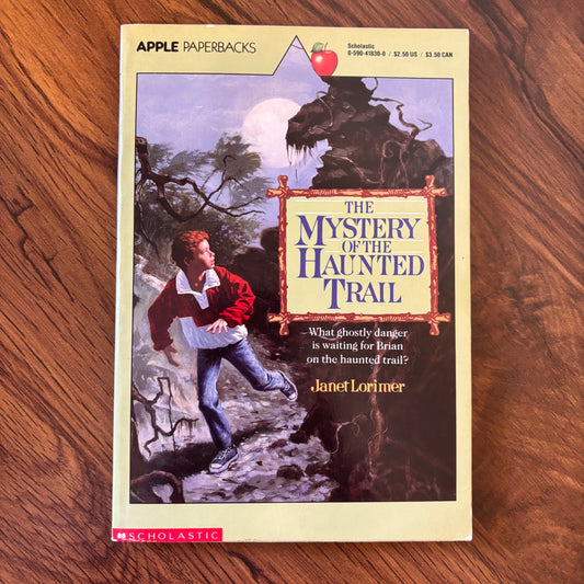 1989 Scholastic paperback The Mystery of the Haunted Trail by Janet Lorimer. Retro 80s mystery book with eerie forest vibes, classic teen suspense, and vintage Scholastic styling.