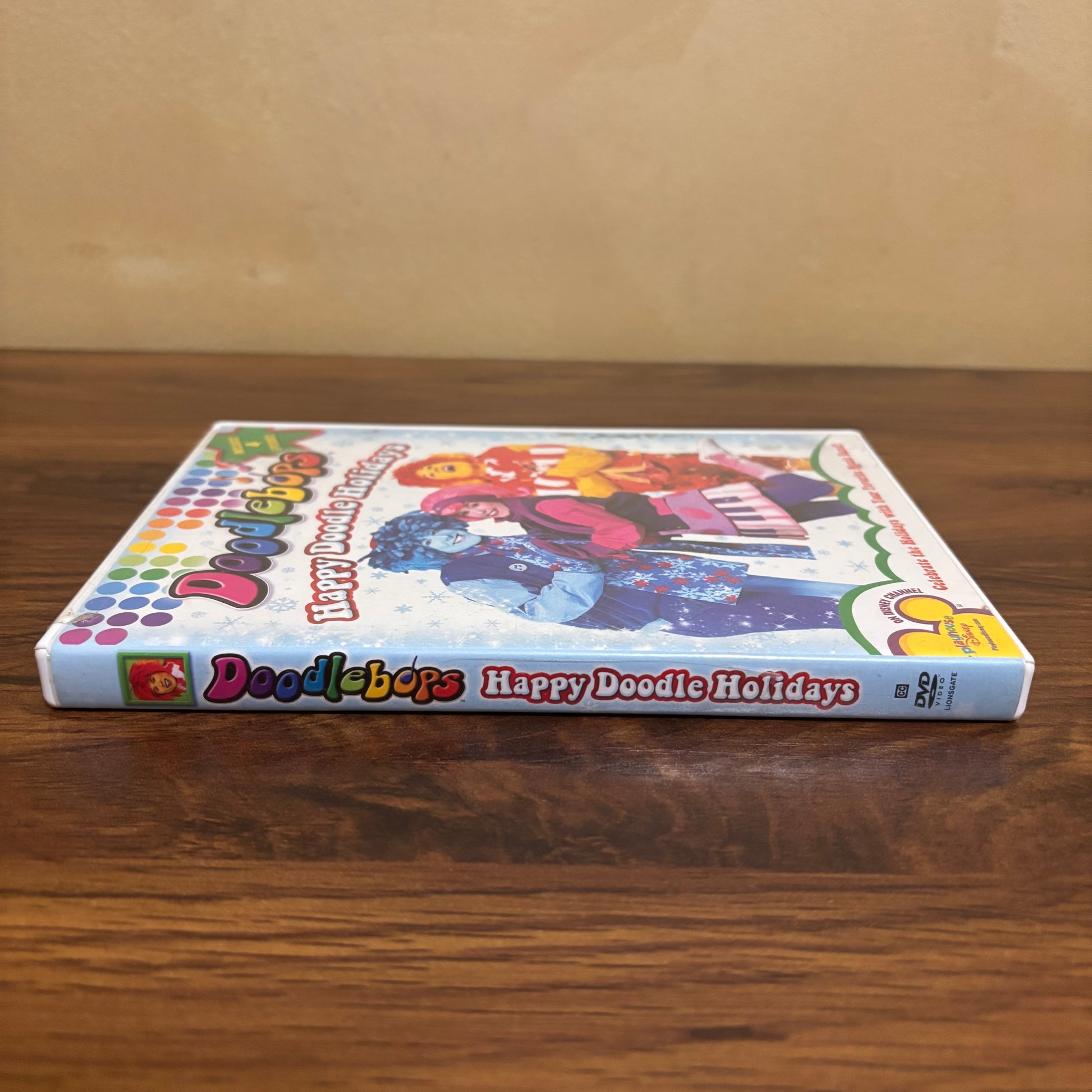 Playhouse Disney era Doodlebops Happy Doodle Holidays DVD with festive cover art, sing-along songs, and nostalgic 2000s preschool show appeal for collectors and families.