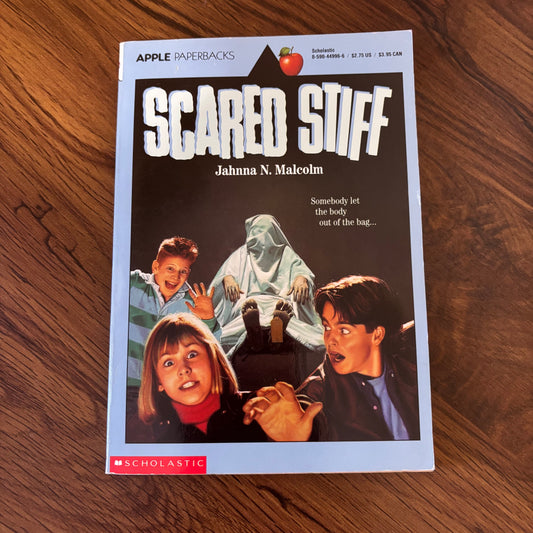 1991 Scared Stiff by Jahnna N. Malcolm, Apple Paperbacks edition from Scholastic. Vintage kids' horror featuring morgues, mischief, and the living dead. A creepy-cool retro read straight from the early 90s shelves of your nightmares. omgihadthat.com