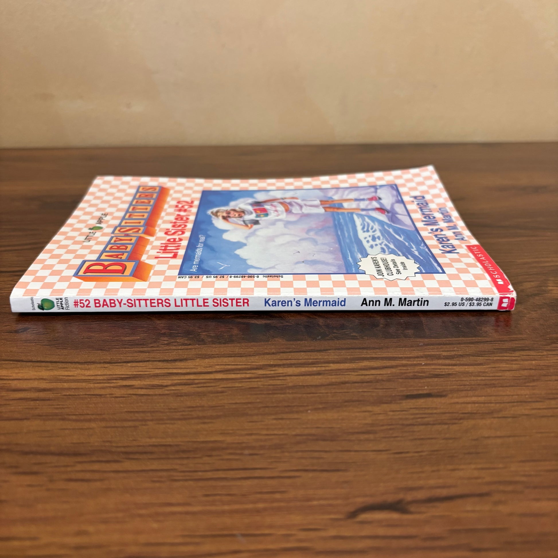 Scholastic Baby-Sitters Little Sister #52 Karen’s Mermaid paperback book with original trading cards still inside, a retro summer chapter book for collectors of vintage kids series books.