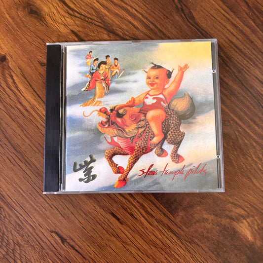 Purple by Stone Temple Pilots, 1994 CD featuring “Interstate Love Song,” “Vasoline,” and more grunge rock gold. A definitive 90s album soaked in alt-rock mood and MTV energy. omgihadthat.com