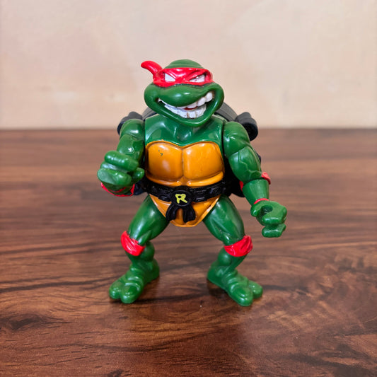 Teenage Mutant Ninja Turtles City Sewer Shell Raphael action figure (1991) by Playmates Toys. Classic retro TMNT collectible - perfect for 90s toy collectors.
