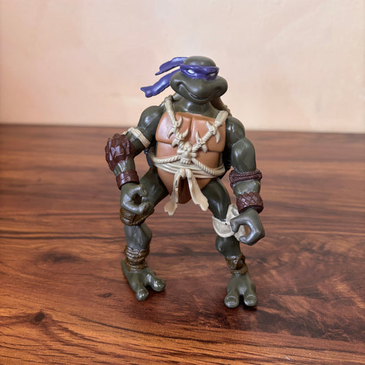 TMNT 2005 Paleo Patrol Donatello action figure, prehistoric Turtles design, rare collectible Teenage Mutant Ninja Turtles toy, perfect for fans and collectors of vintage TMNT.