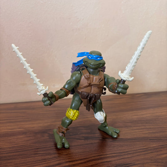 TMNT 2005 Paleo Patrol Leo action figure, Jurassic Age Leonardo design, collectible Teenage Mutant Ninja Turtles toy, great for fans and collectors.