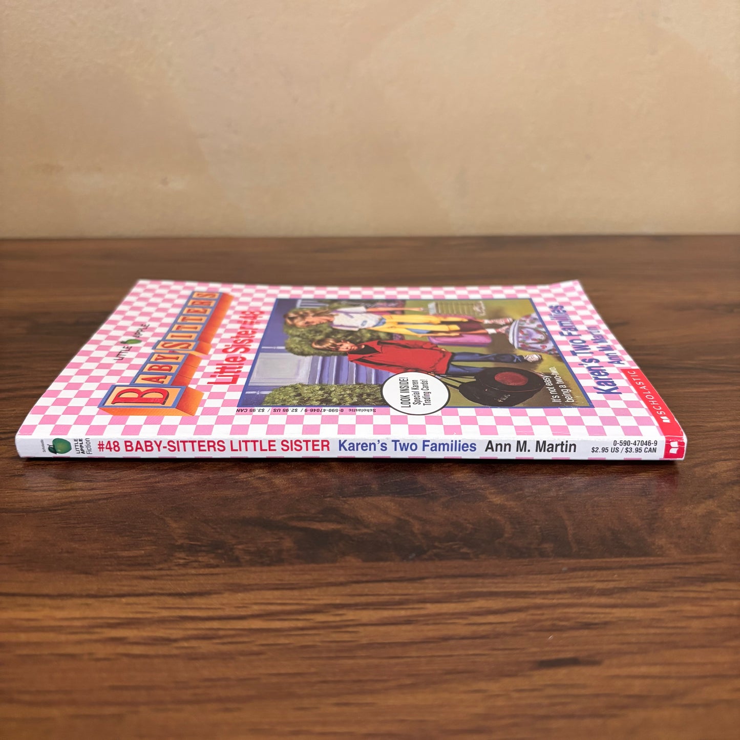 Vintage Karen’s Two Families paperback book from the Baby-Sitters Little Sister series, a relatable story about adjusting to two families and missing a parent, with bonus cards still attached inside.