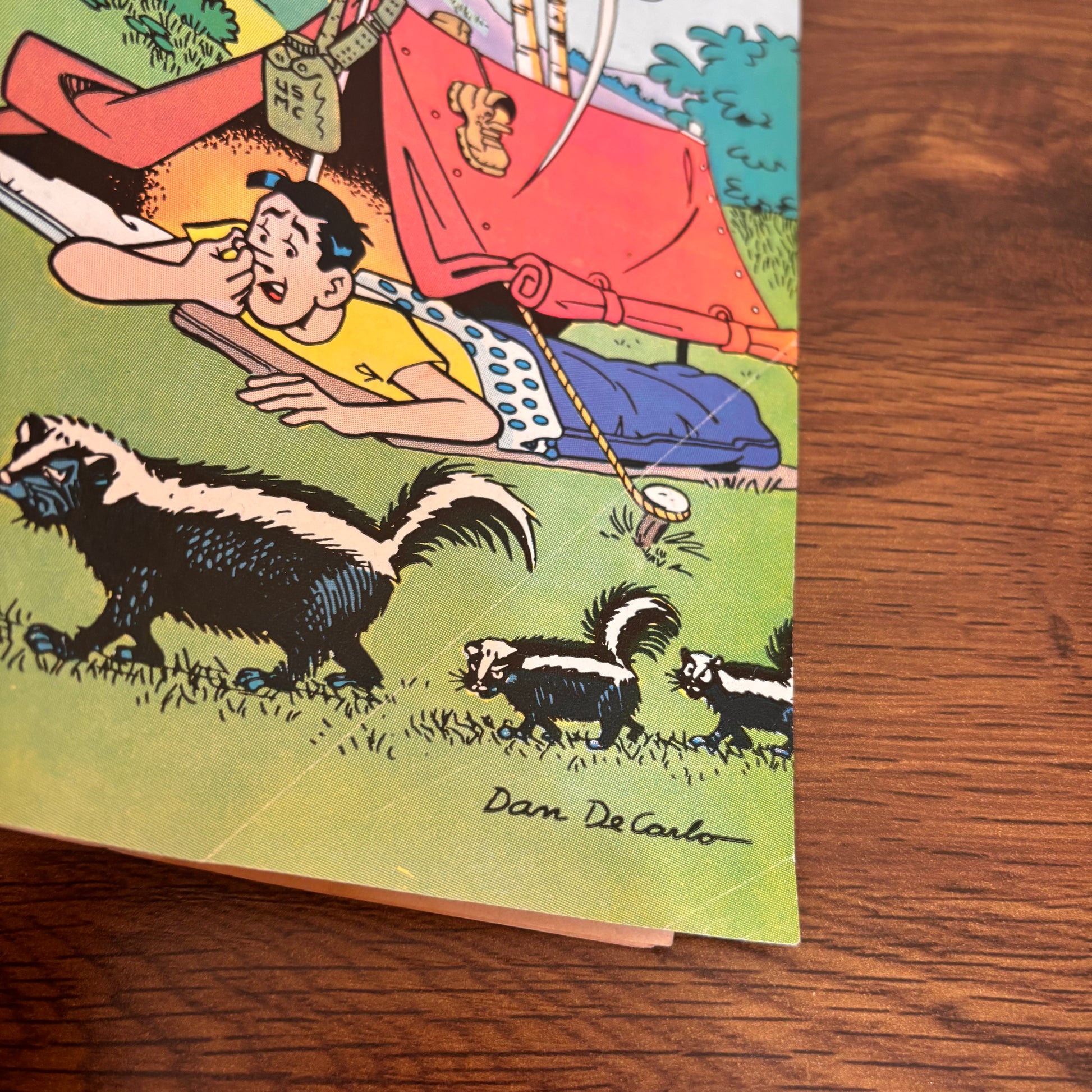 Vintage Riverdale comic starring Jughead in a camping trip cover scene, with tents, nature, skunks, and the lighthearted Archie Comics humor fans remember.